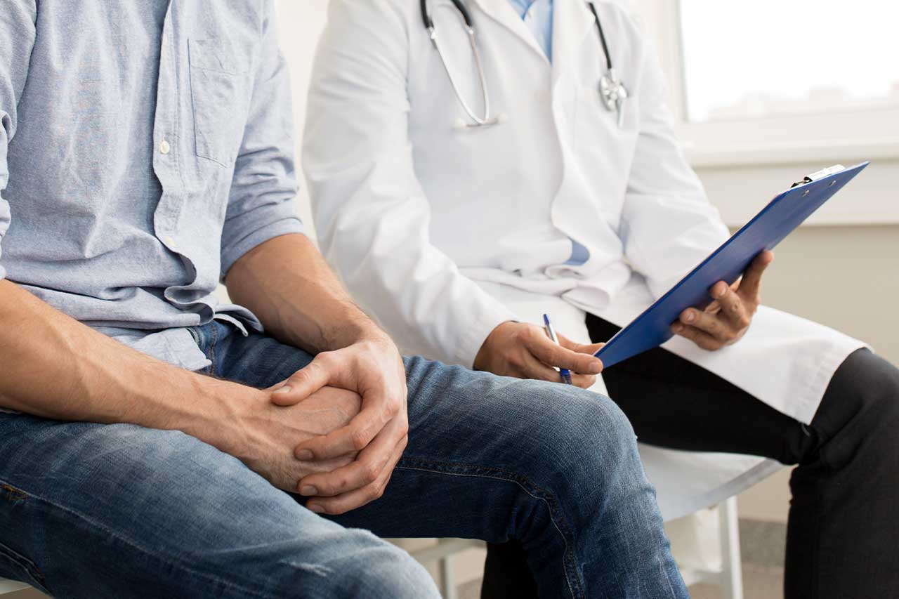 man sitting with doctor in his office