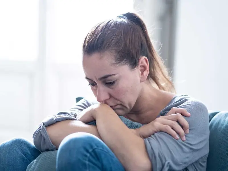 woman sitting on the ground isolated during COVID-19
