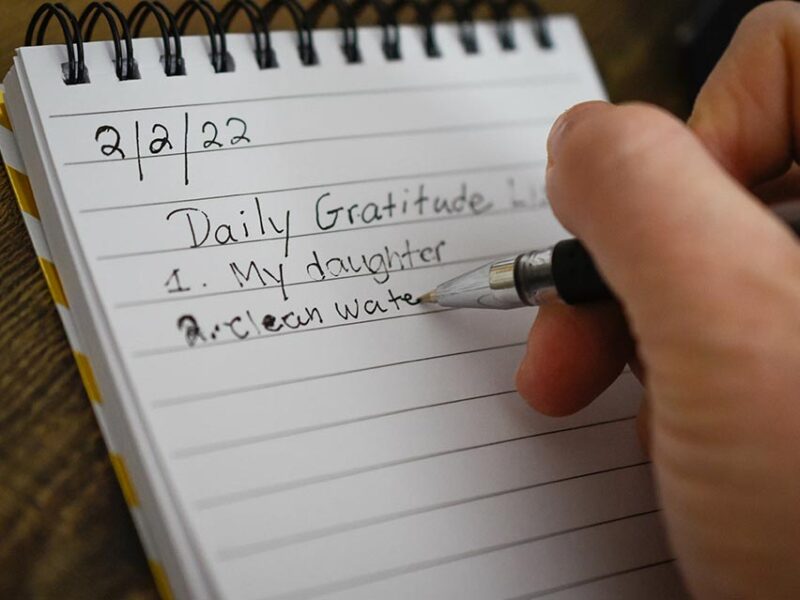 person practicing gratitude journal writing