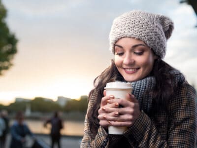 holding coffee in chilly weather