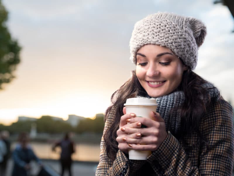 holding coffee in chilly weather