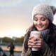 holding coffee in chilly weather