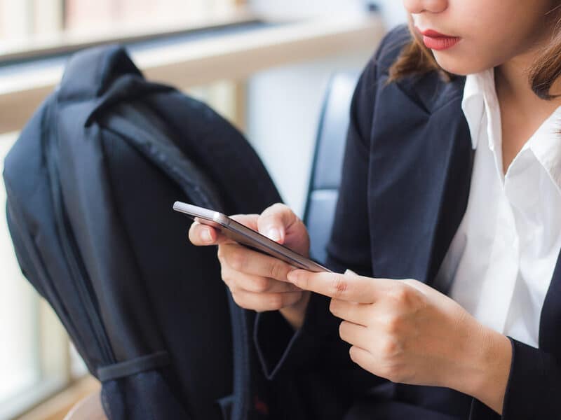 traveling lady with phone at airport