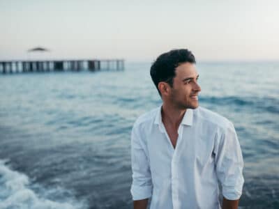 man with ocean and pier in background