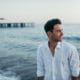 man with ocean and pier in background