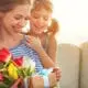 mother and daughter with present and tulips