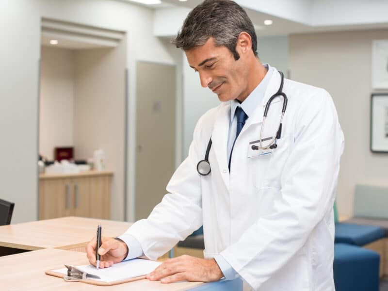 doctor writing results happy