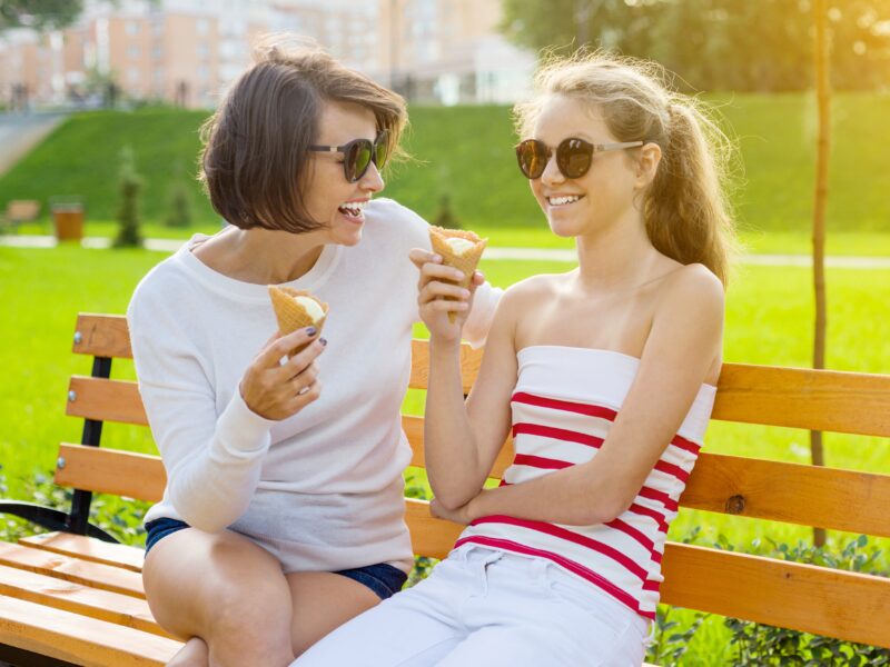 woman and daughter enjoying icecream cone