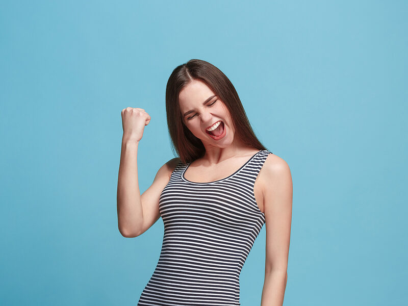 women clutching success fist