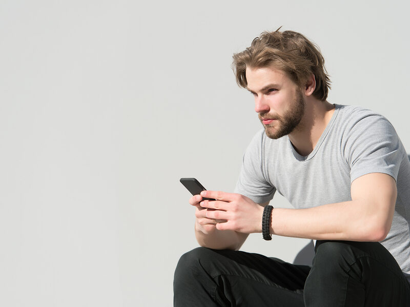 man thinking with phone