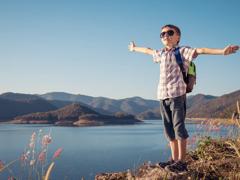kid hiking lake view