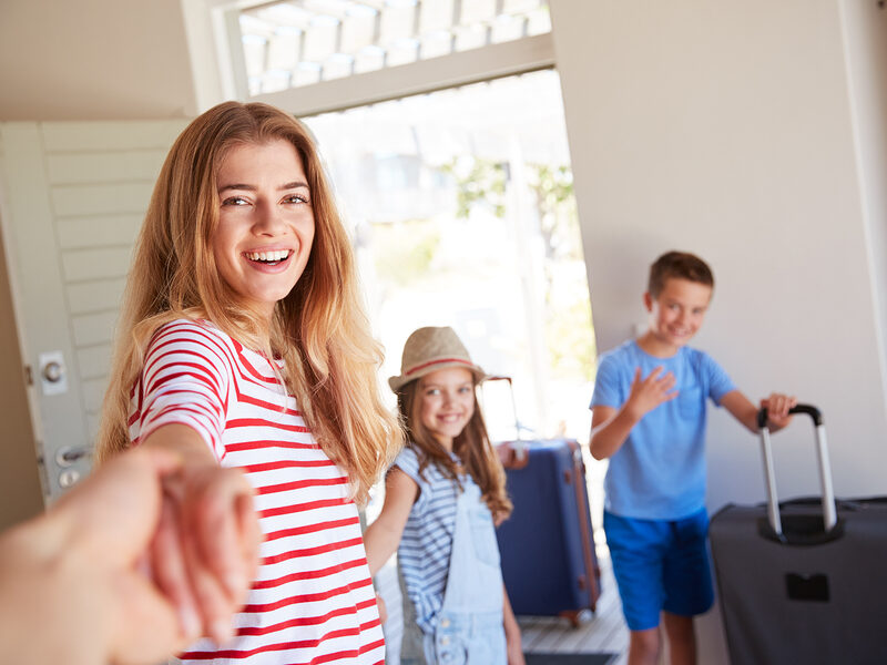 family arriving in house and happy