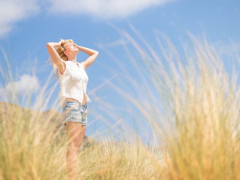 lady enjoying the sun with closed eyes