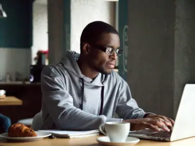 young black man on laptop