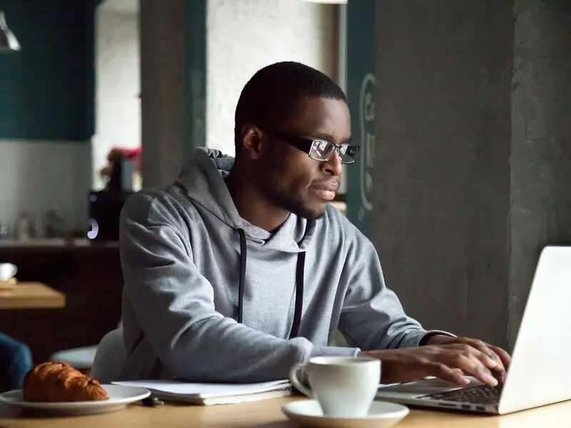 young black man on laptop
