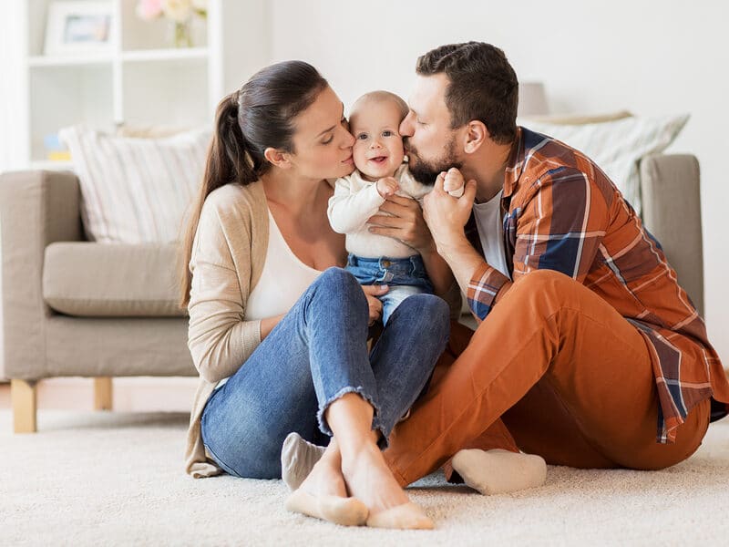 parents with infant on floor