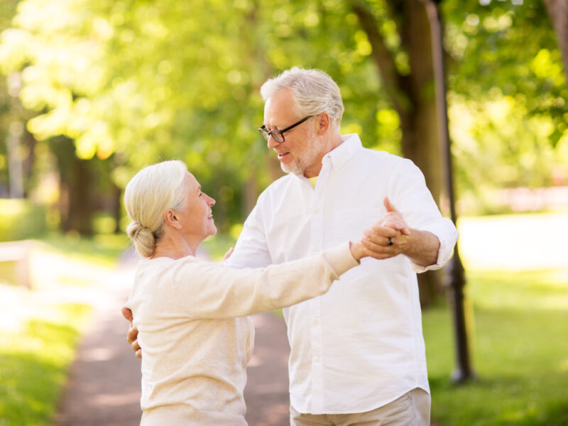 dancing seniors under a tree