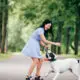 women and dog outdoor playing