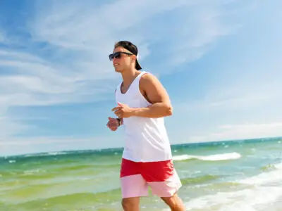 man jogging beach shoreline