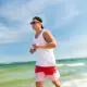 man jogging beach shoreline