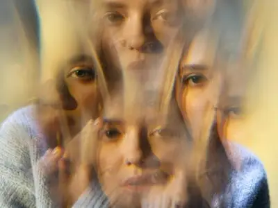A depiction of a woman hallucinating, seeing multiple of herself.