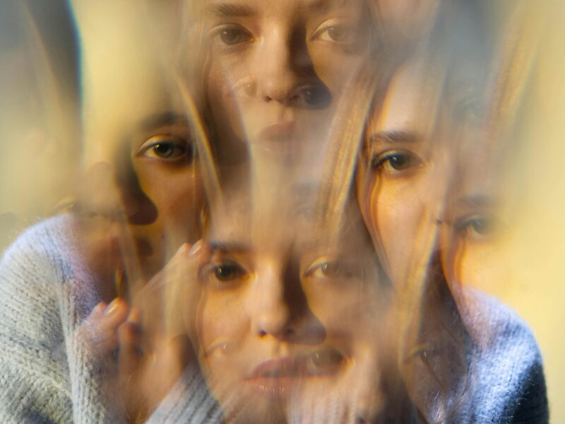 A depiction of a woman hallucinating, seeing multiple of herself.