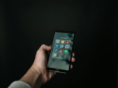 iphone with social media apps in a dark room
