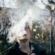 teen blowing a cloud of smoke from vaping.