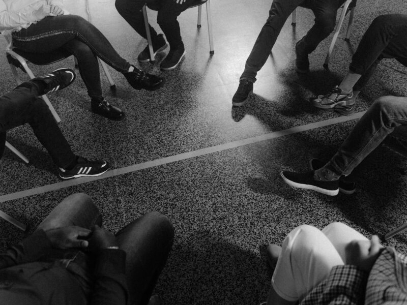 group therapy session with individuals sitting in a circle.