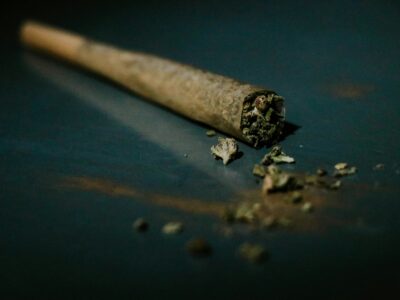 a rolled marijuana joint, laying on a flat surface.