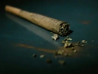 a rolled marijuana joint, laying on a flat surface.