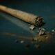 a rolled marijuana joint, laying on a flat surface.