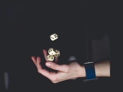 a hand stretched out catching dice that were tossed.