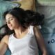 a woman at peace sleeping on her bed