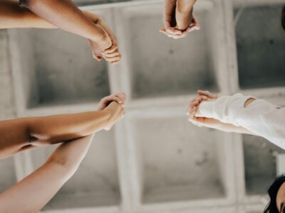 a group of people joining hands in unity