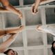 a group of people joining hands in unity