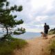 a man walking a nature trail with his dog