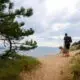 a man walking a nature trail with his dog
