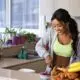 a woman preparing a healthy meal with fruit and vegetables.