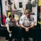 two first responders sitting in the back of their rig hunched over
