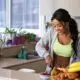 Woman preparing fresh fruits and vegetables in kitchen